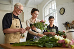 Corporate team collaborating at Team Posy Challenge floral workshop in Auckland
